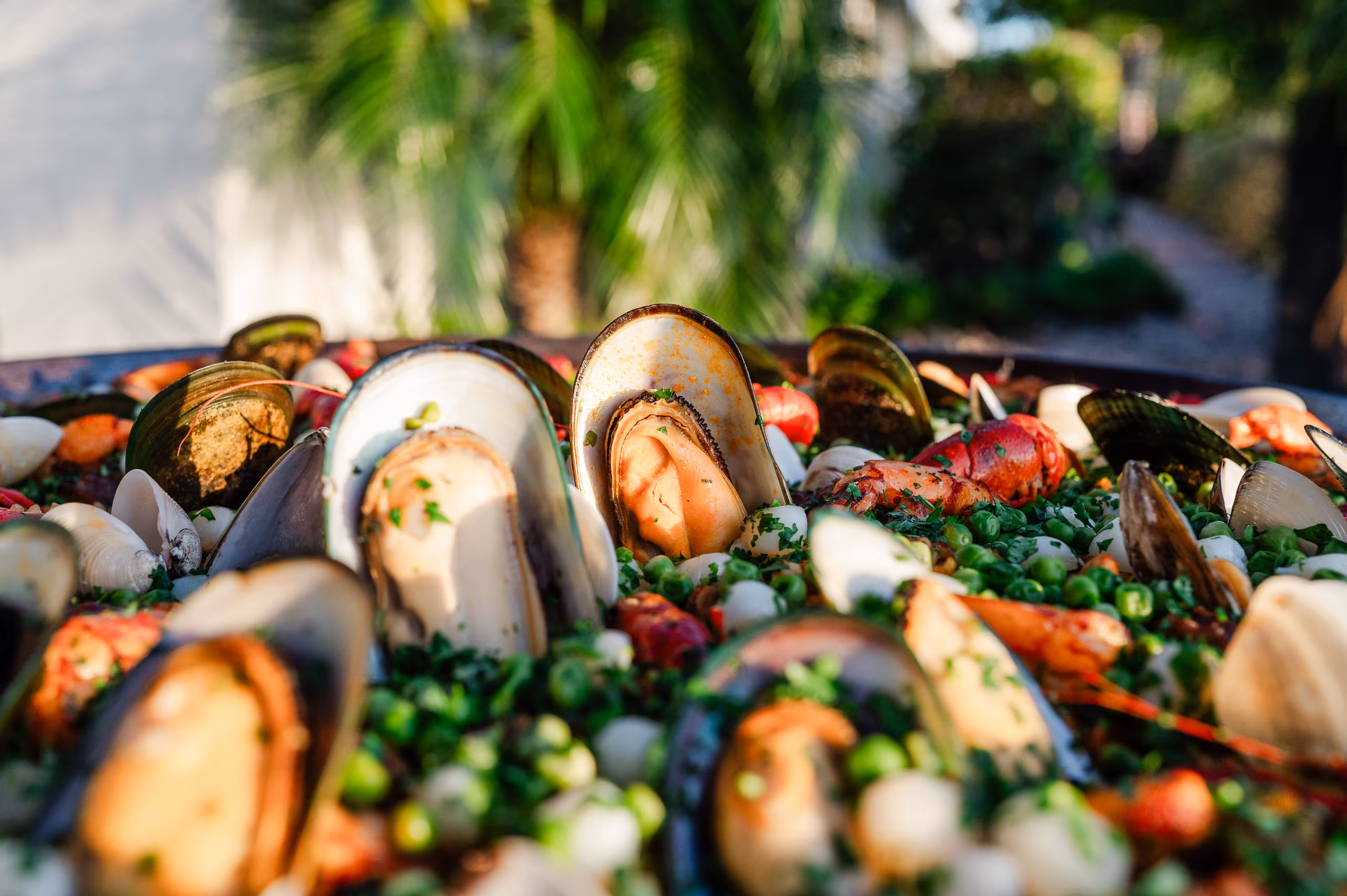 A platter of steamed mussels with peas and fresh herbs